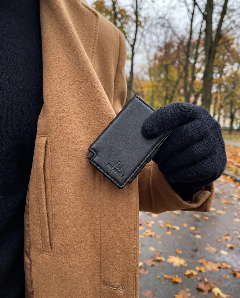 Luzof slid into the inner pocket of a camel coat